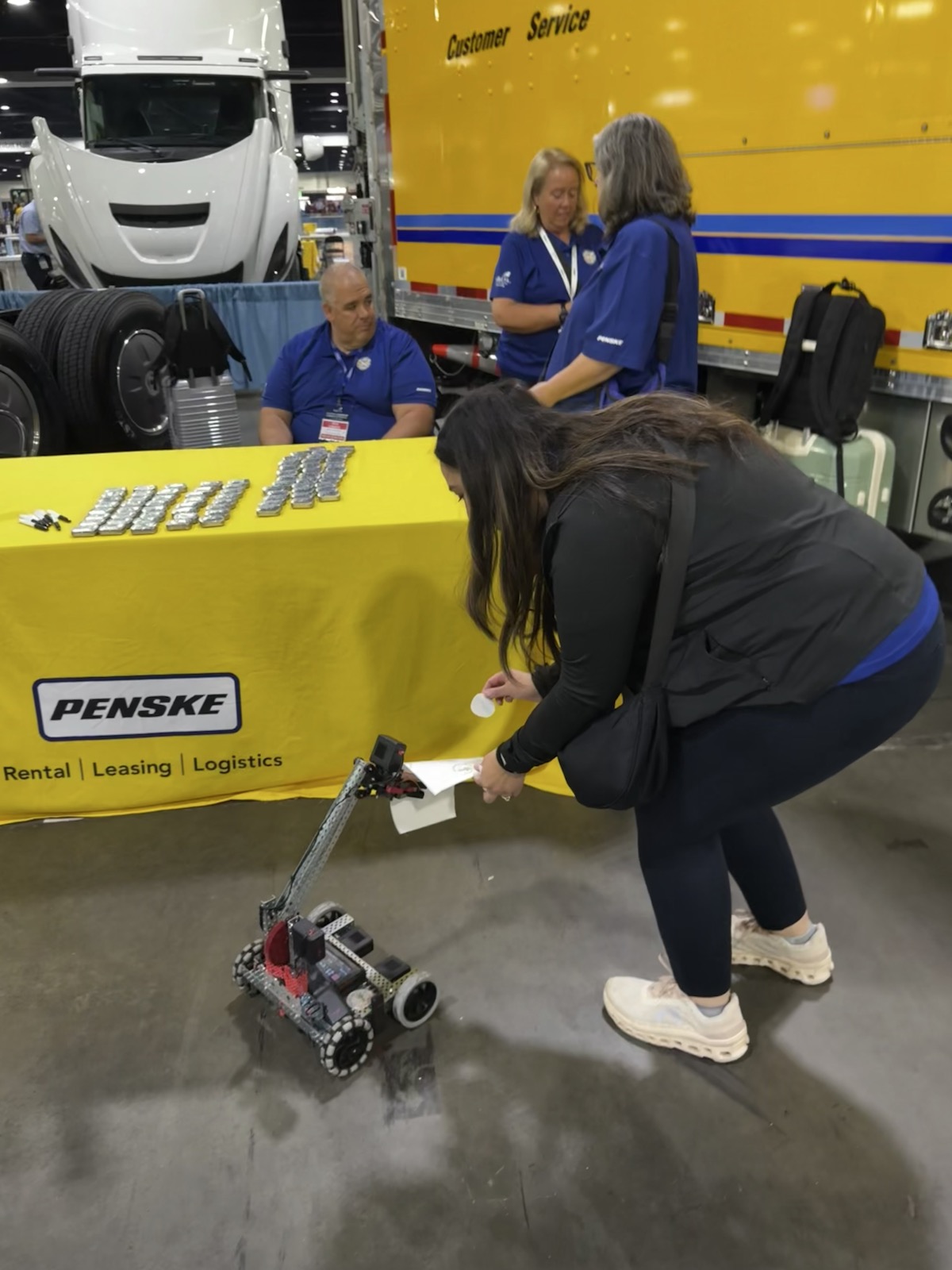 A robotics demonstration near a SkillsUSA exhibitor booth.